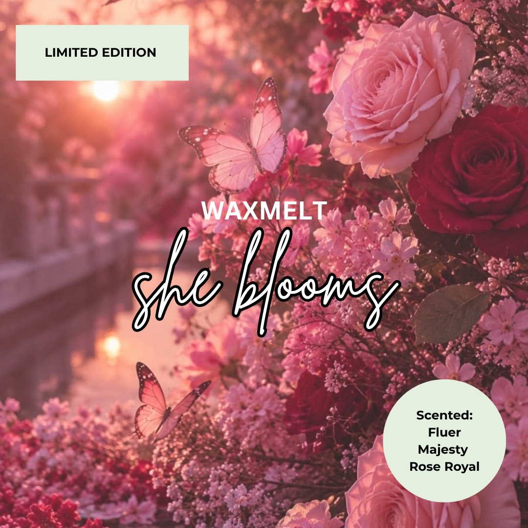 Scented wax melt packaging design for 'she blooms' by WAXMELT, featuring a romantic pink and red floral arrangement with butterflies in a sunlit garden scene. Includes 'LIMITED EDITION' and scent notes for 'Fluer', 'Majesty', and 'Rose Royal' in circular labels.