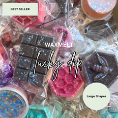 A collage of colorful wax melts in various shapes, each individually wrapped in clear plastic. The products feature glitter, resin details, and pastel colors including pink, dark brown, teal, and purple.